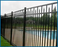 Picture of wrought iron fence with double rail on top, with every other picket having spear points.