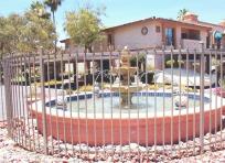 Picture of fence around a fountain. Custom fountain fence enclosure with spear tops.